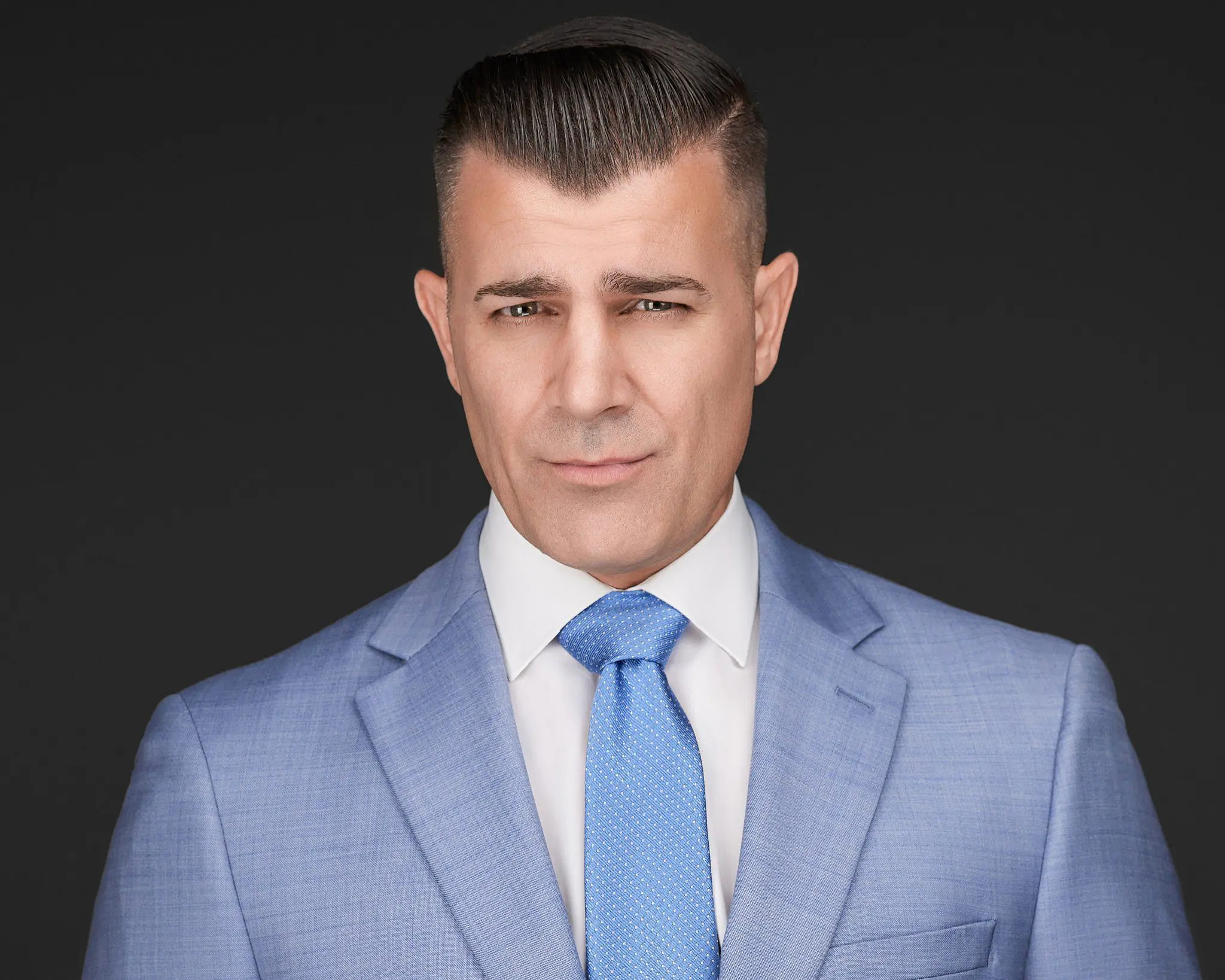 Man professional headshot in a suit and tie