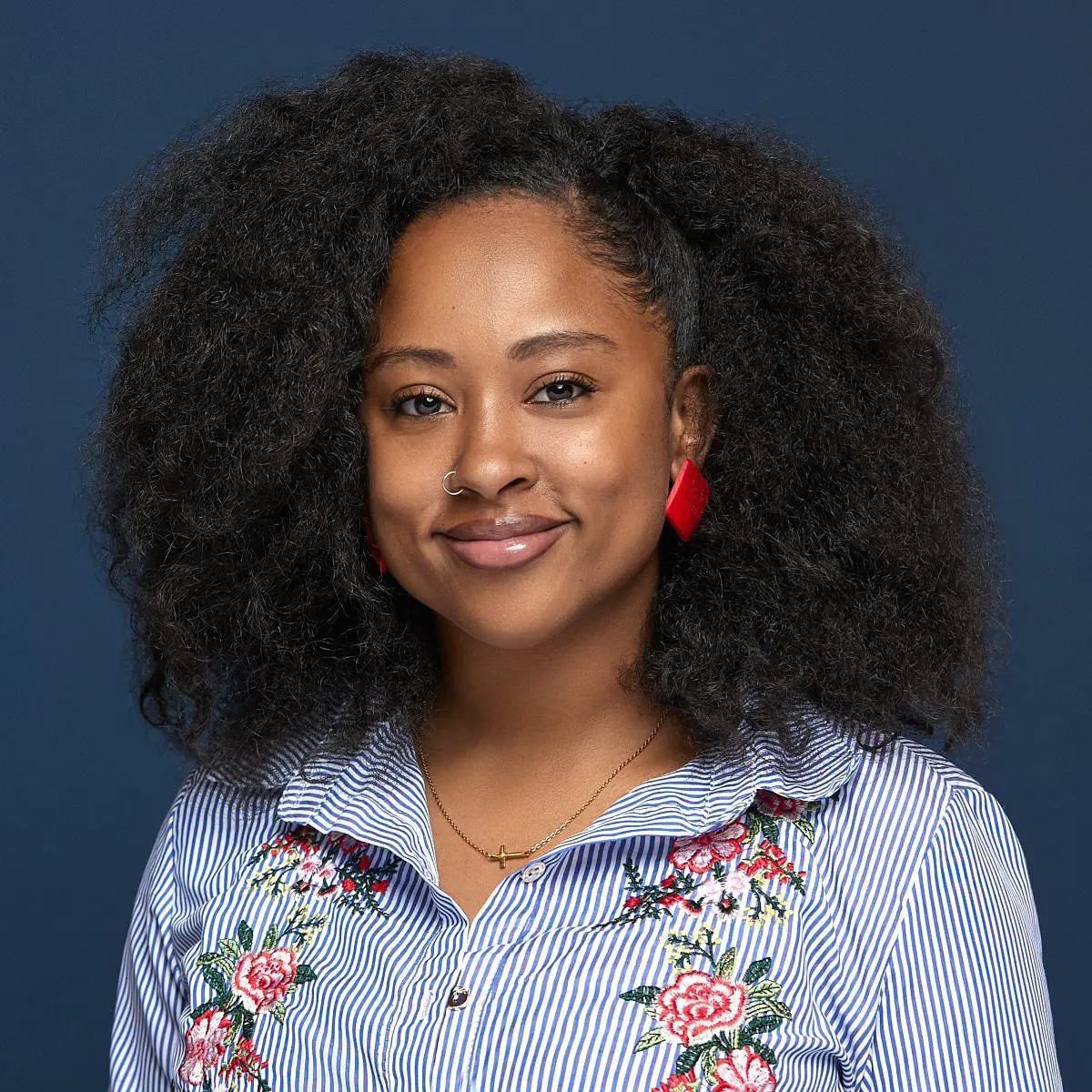 African American professional woman headshot with bright red earring