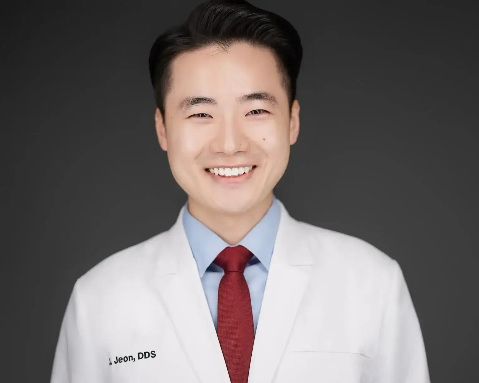 Dentist professional headshot in a white coat