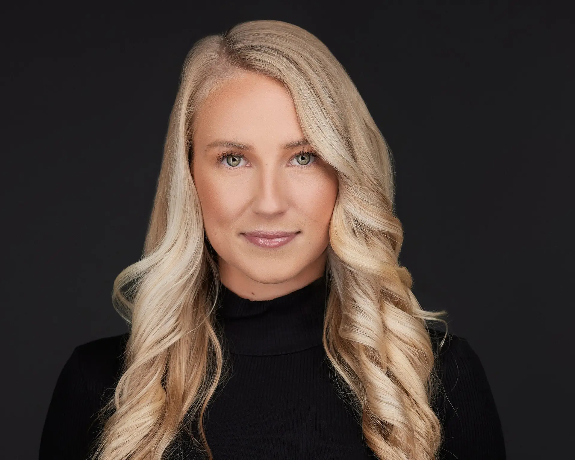 young professional woman headshot on dark background