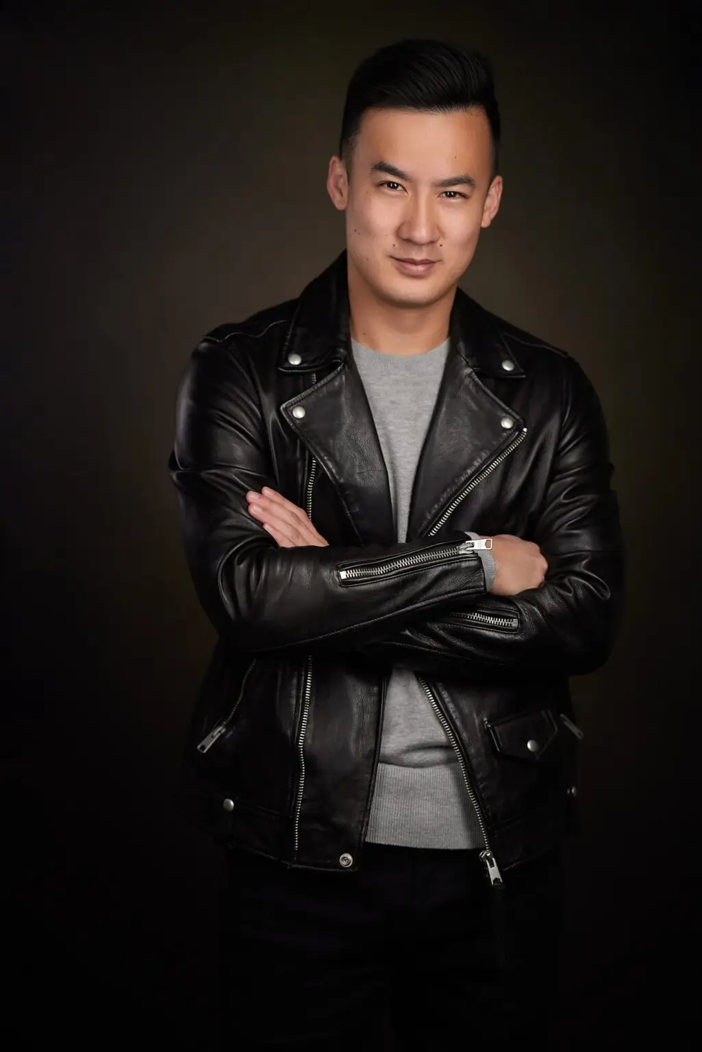 Professional headshot of a business person in a leather jacket