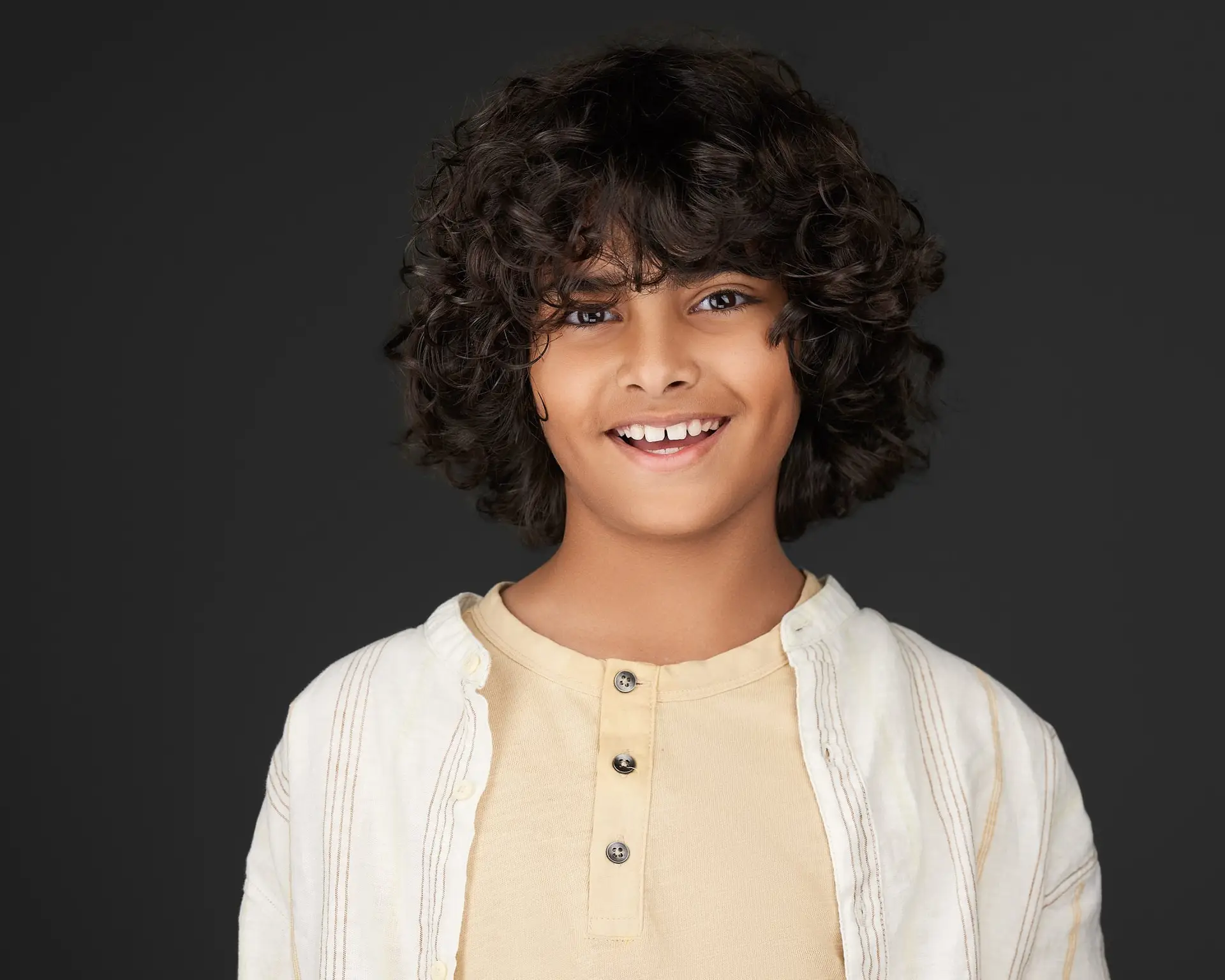 Young actor with curly hair headshot