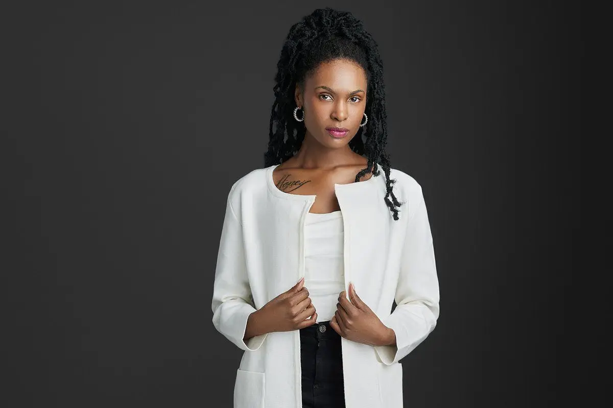 half body professional headshot of a woman in a white jacket